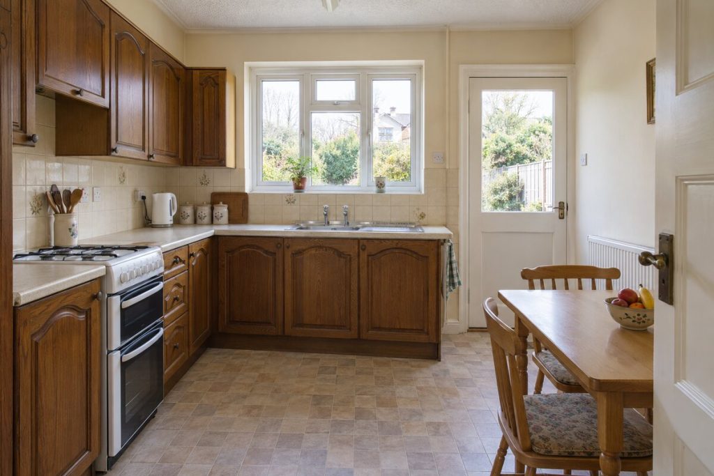 Kitchen in a dated but clean 1930s semi, magnolia walls and original kitchen
