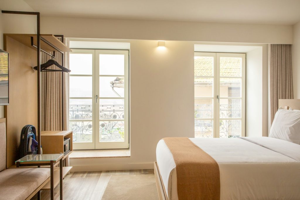 Bright studio flat with a double bed beside tall French windows