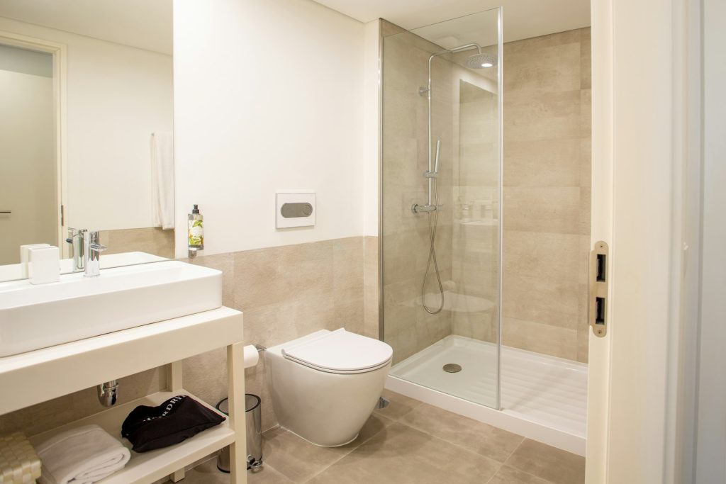 Bathroom with a walk-in shower, basin unit and wall-hung toilet