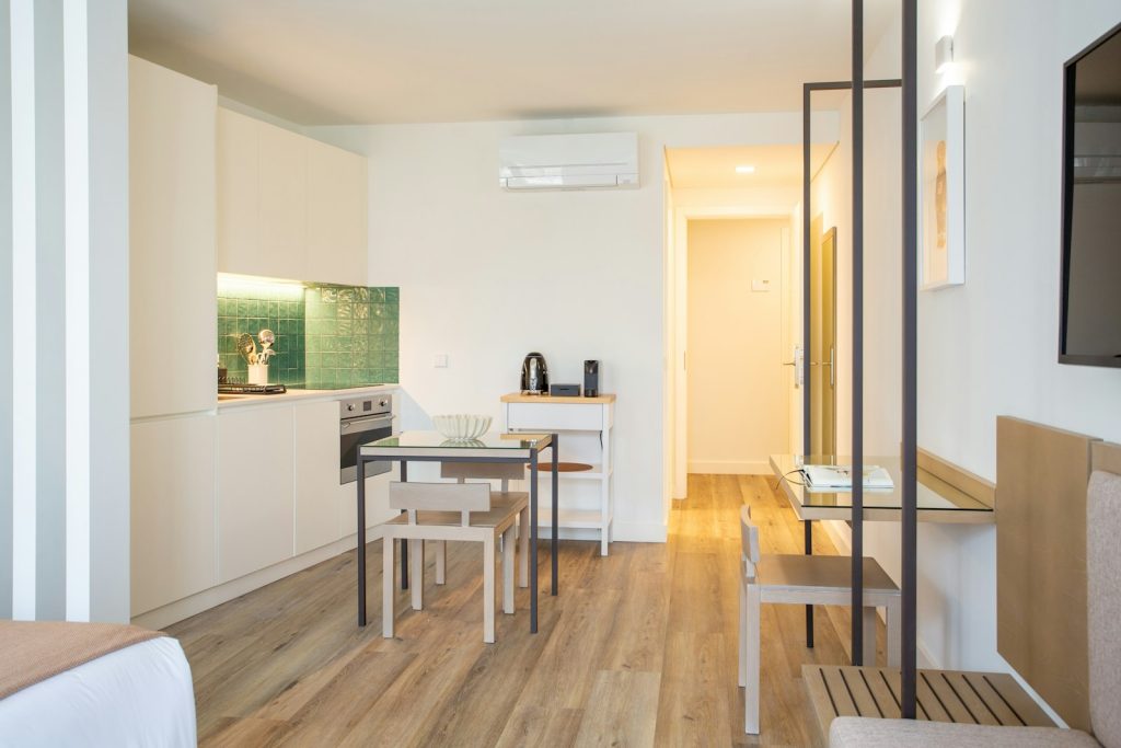 Kitchenette and small dining table in a light studio flat