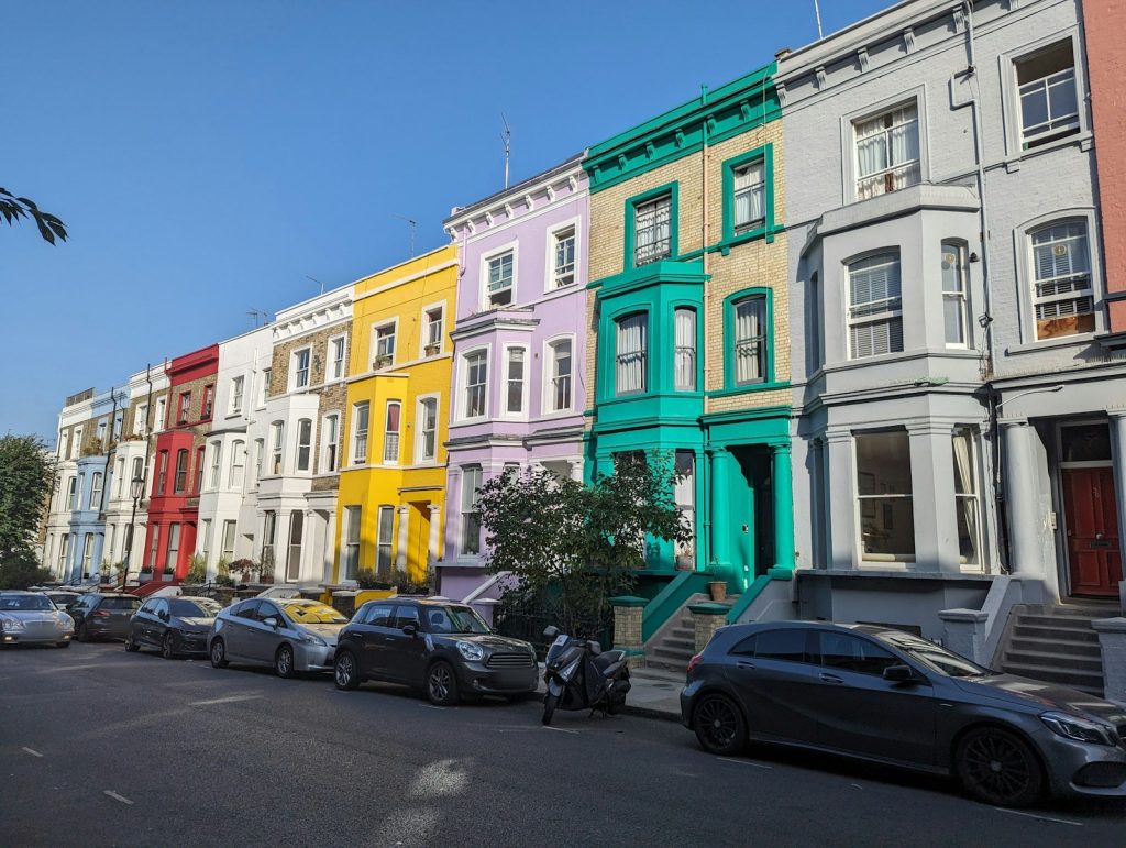 Row of brightly painted Victorian terraced houses with bay windows