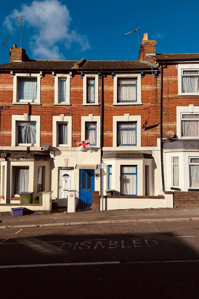 Edwardian red brick terraced houses with bay windows and a blue front door