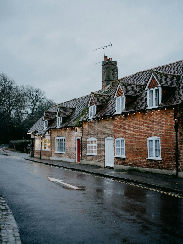 Row of Victorian brick terraced houses on a damp day