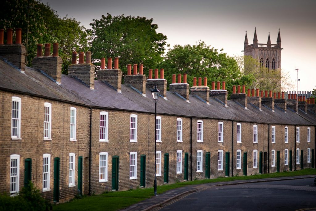 Long Victorian brick terrace seen from across a park