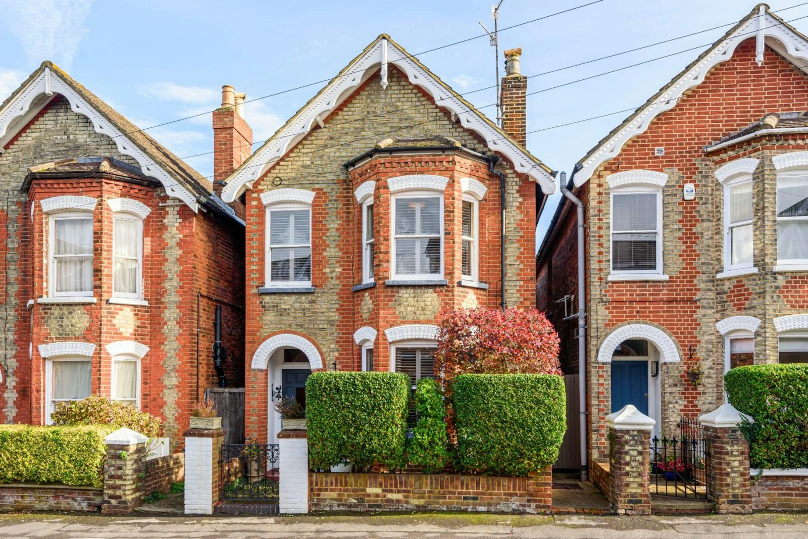 Edwardian red brick semis with gabled bays and white windows