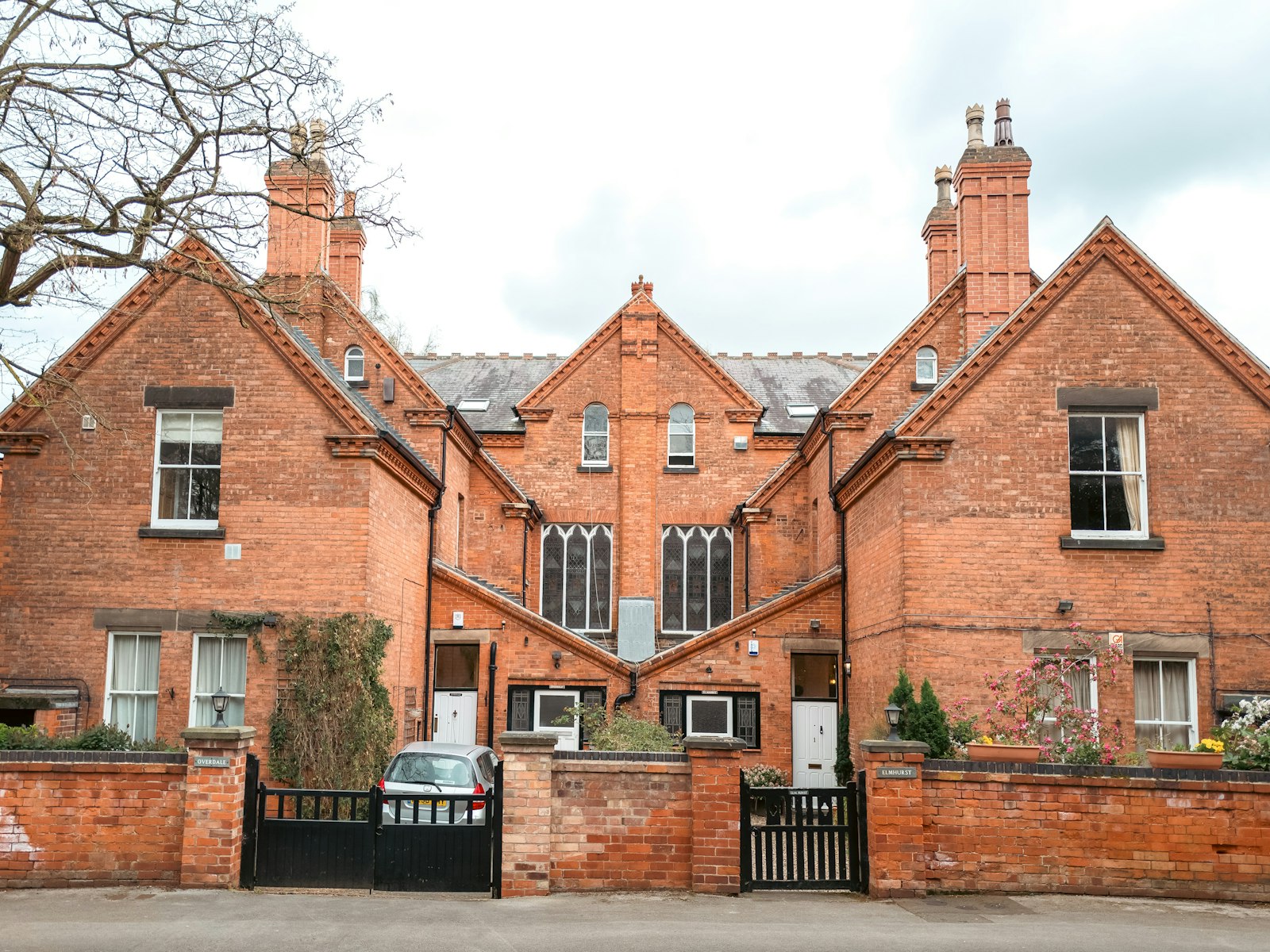 Symmetrical Edwardian brick pair behind a black gate
