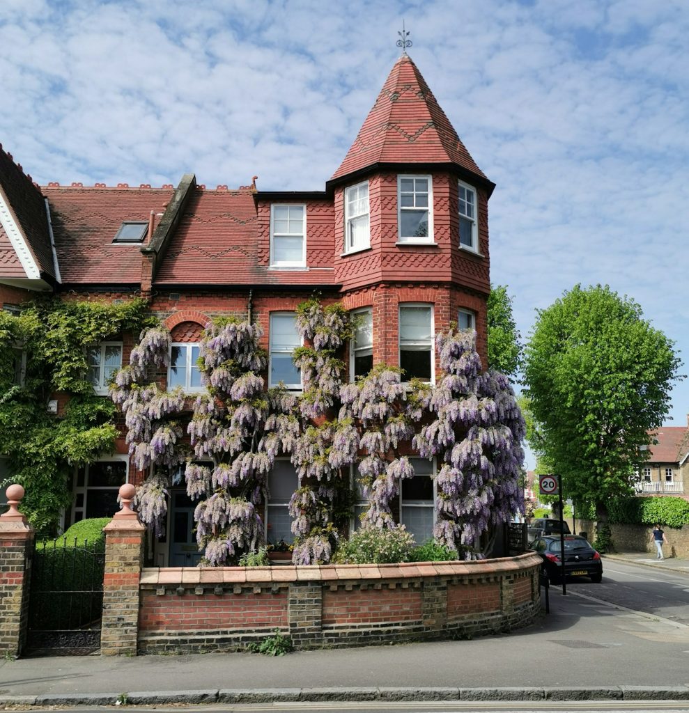Large Edwardian red brick house with wisteria