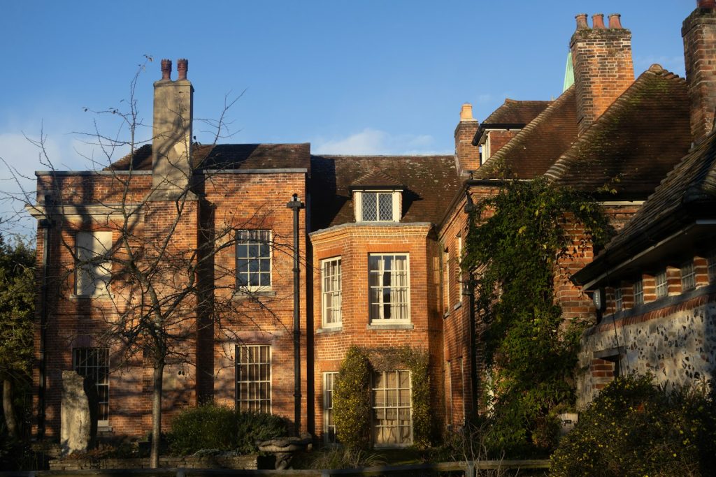 Old brick house with tall chimneys and sash windows