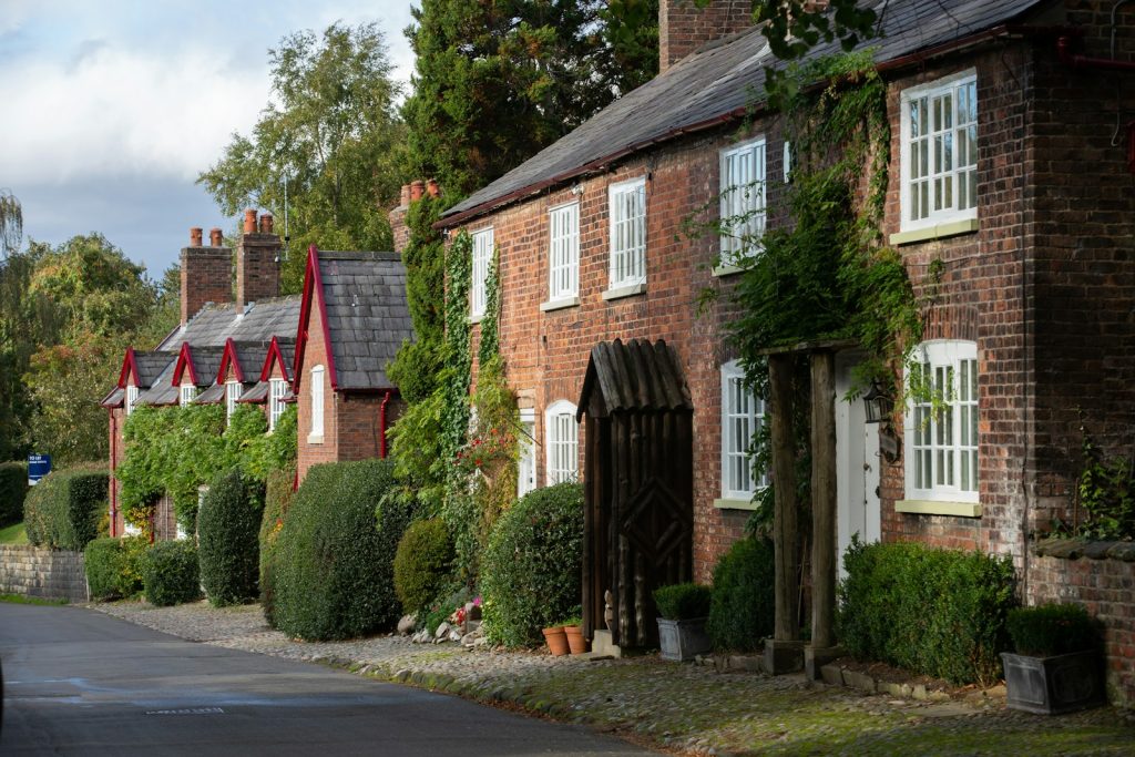 Brick cottages set among climbing plants