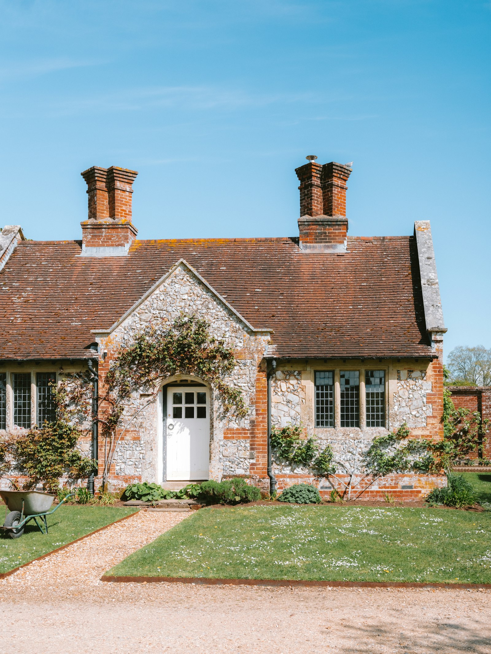 Flint and brick cottage with a red tiled roof