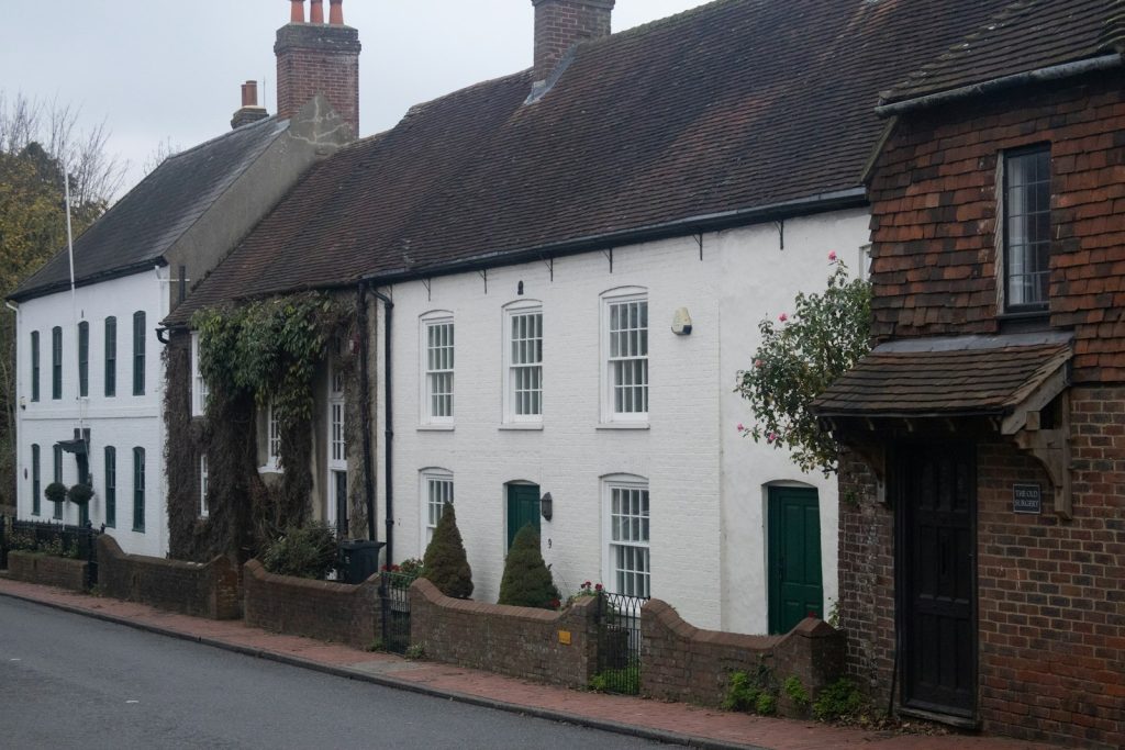 Painted cottages with a tile-hung end along a village street