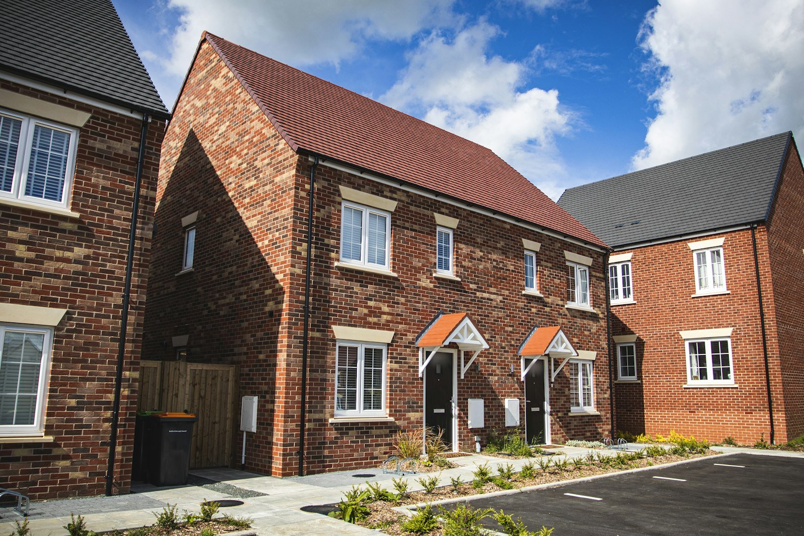 Modern brick semi-detached pair with canopy porches from the front corner