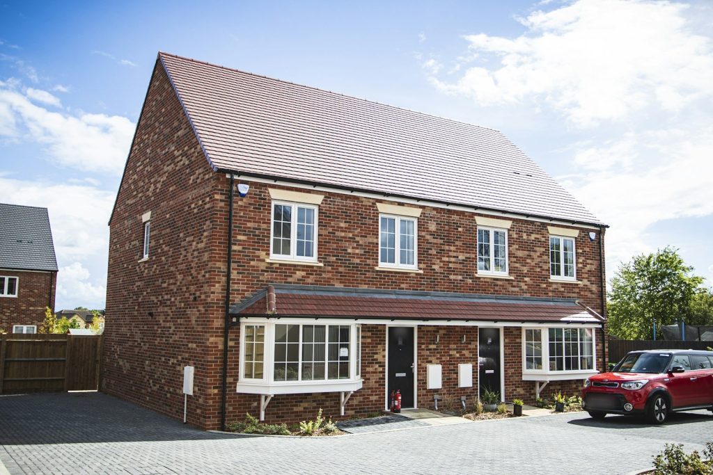 Modern brick semi-detached pair with bay windows and a shared porch roof