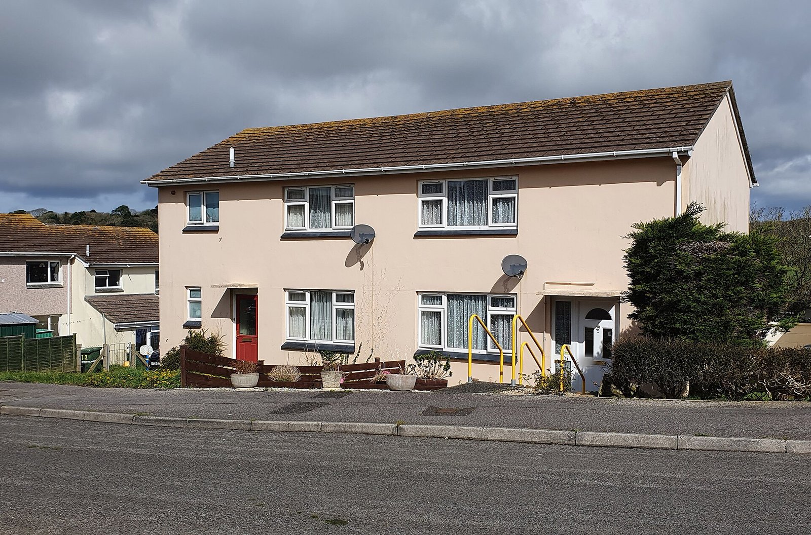 Postwar rendered semi-detached pair with red and white doors, Penzance, Cornwall