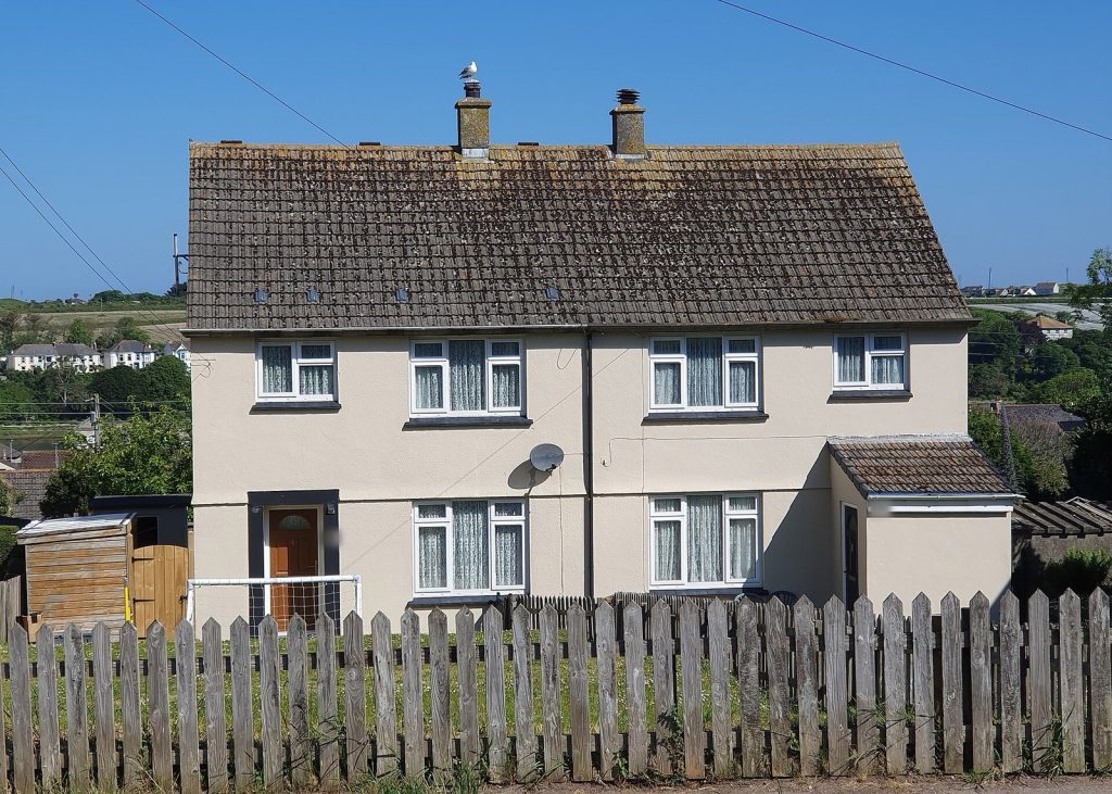 Postwar rendered semi-detached pair behind a picket fence, Hayle, Cornwall