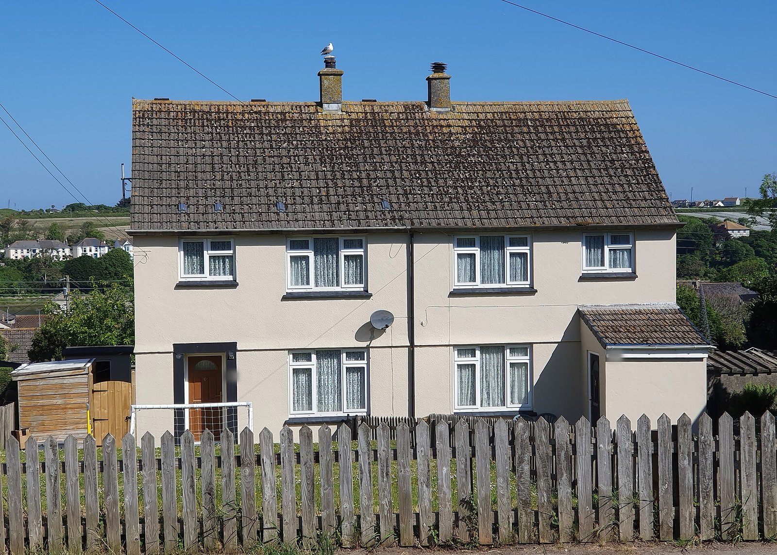 Postwar rendered semi-detached pair behind a picket fence, Hayle, Cornwall
